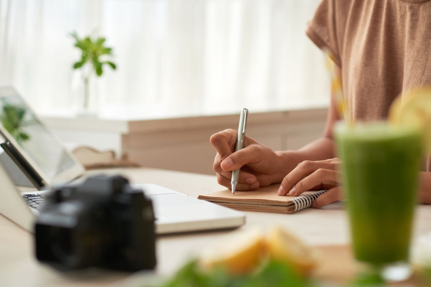 Professional discussion around a notebook in a bright workspace